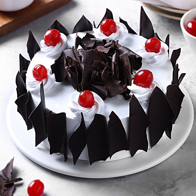 Eggless Black Forest cake with cherries and chocolate shavings